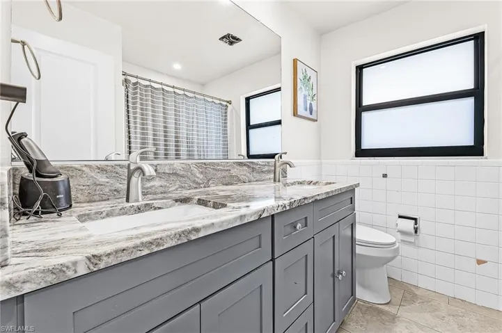 Guest Bathroom with new vanity and newer tile floors and impact window
