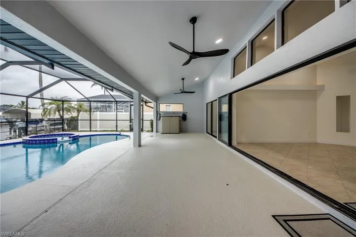 View of pool featuring ceiling fan