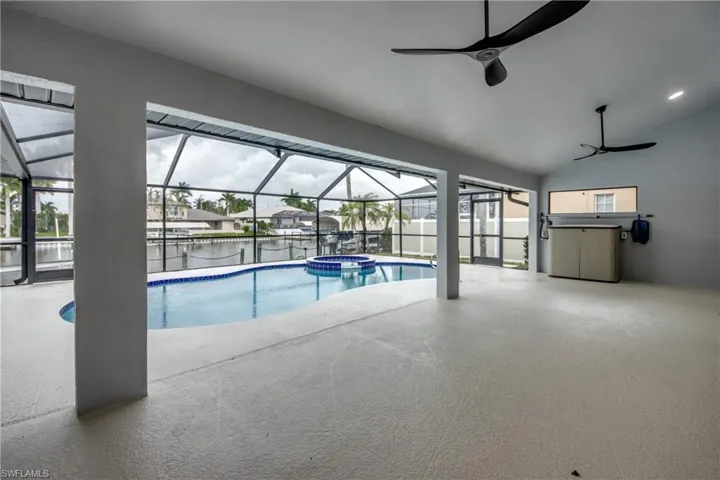 View of swimming pool with ceiling fan