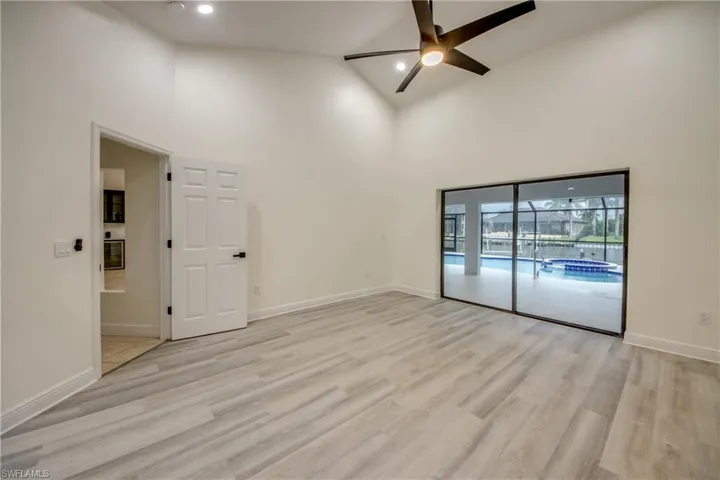 Unfurnished room featuring high vaulted ceiling, ceiling fan, and light hardwood / wood-style flooring