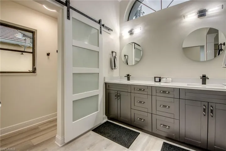 Bathroom featuring dual vanity and hardwood / wood-style floors