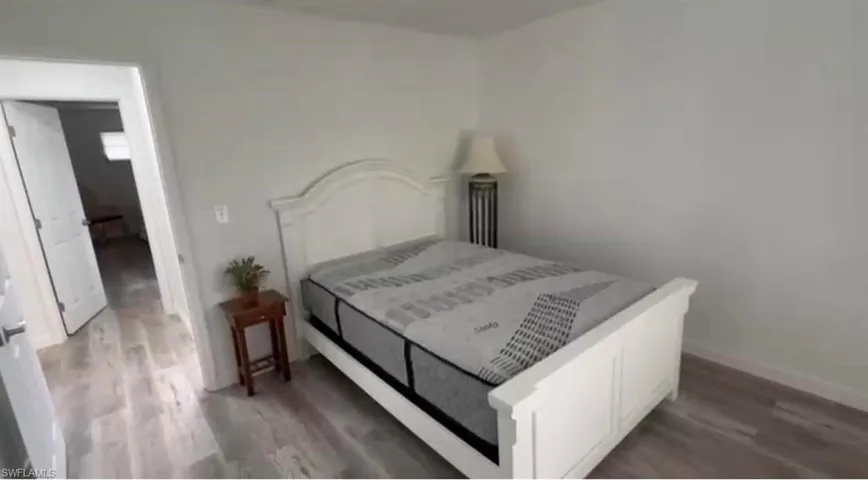 Bedroom featuring dark wood-style floors