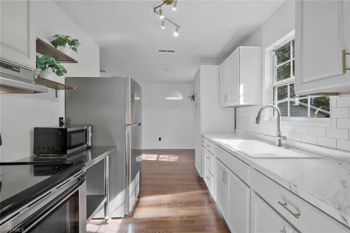 Primary suite, bathroom through left door, walk-in closet through right door