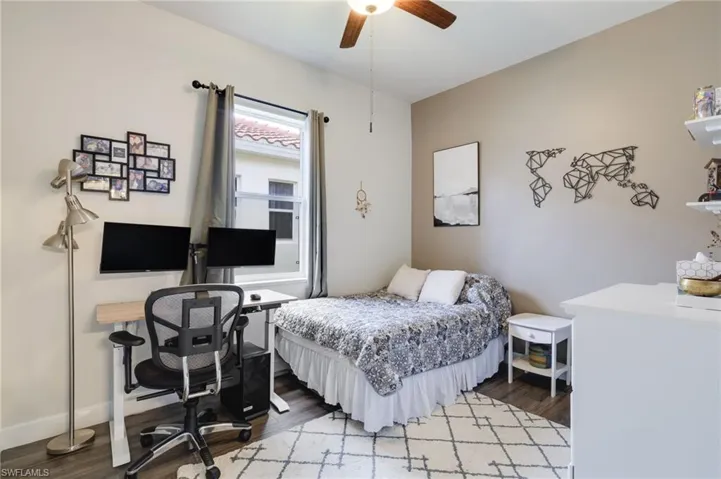 Bedroom with ceiling fan and hardwood / wood-style flooring