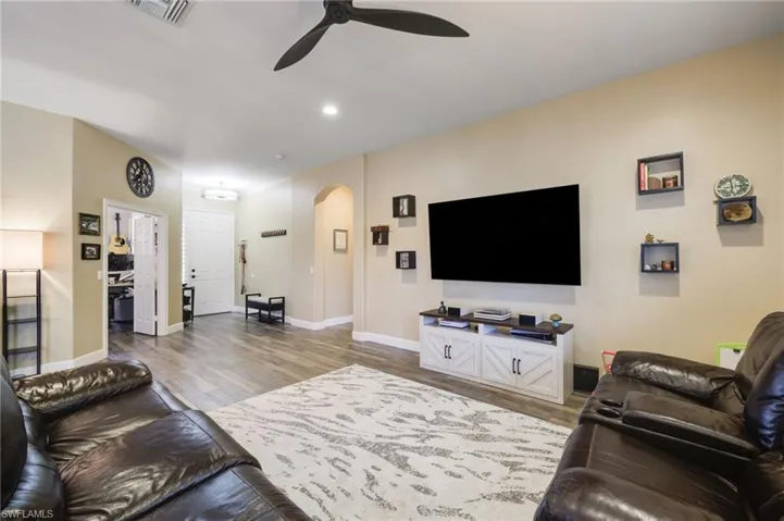 Living room featuring ceiling fan and hardwood / wood-style floors
