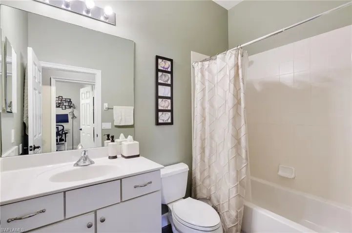 Full bathroom with shower / bath combo, vanity, and toilet