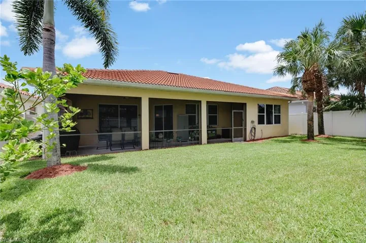 Rear view of house featuring a yard