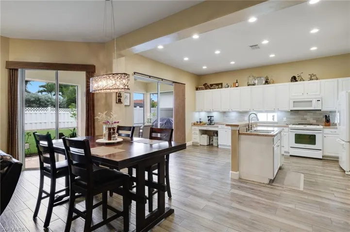 Dining room featuring sink and light hardwood / wood-style flooring