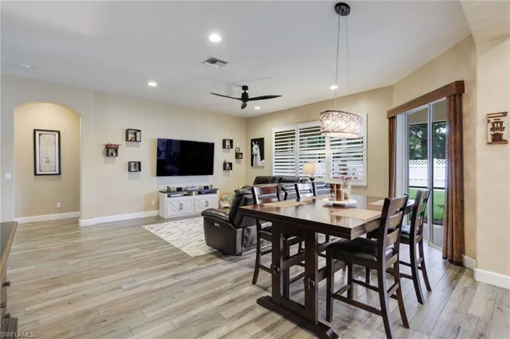Dining room with ceiling fan and light wood-type flooring