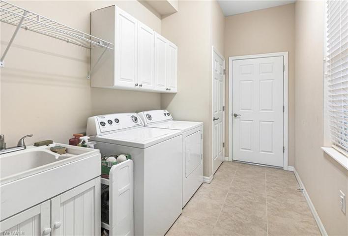 Large laundry room with additional cabinets and sink