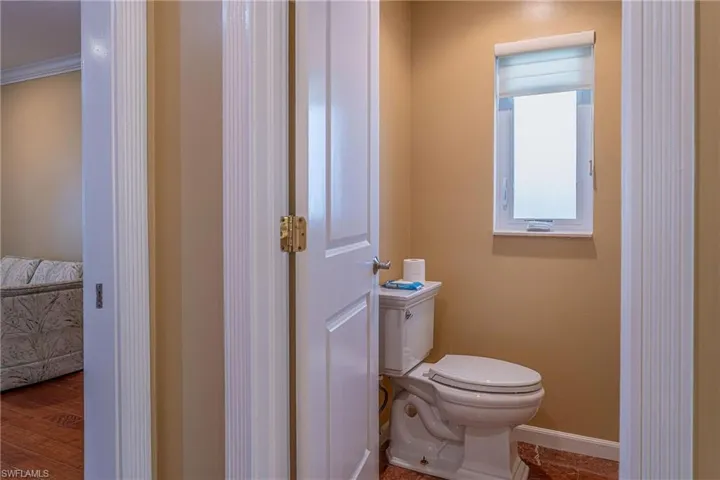 Half bathroom featuring toilet and baseboards