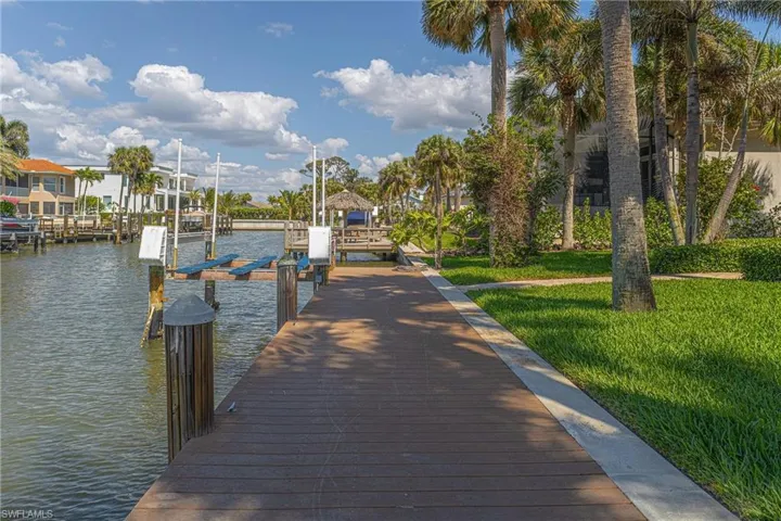 Dock area featuring a water view, a yard, and boat lift