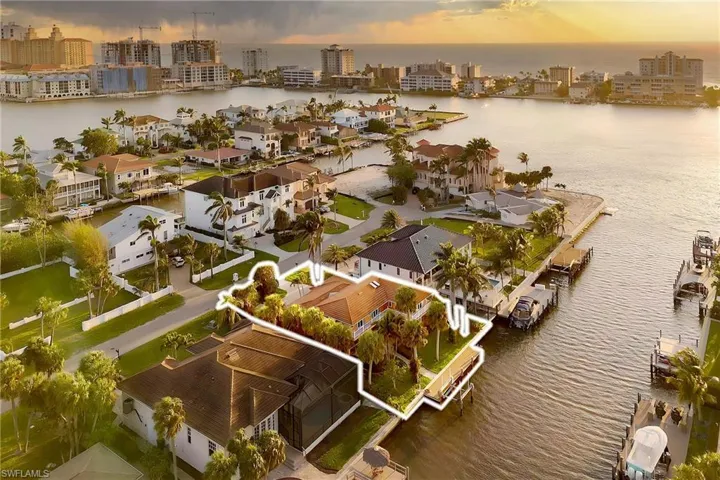 Aerial view featuring a city view and a water view