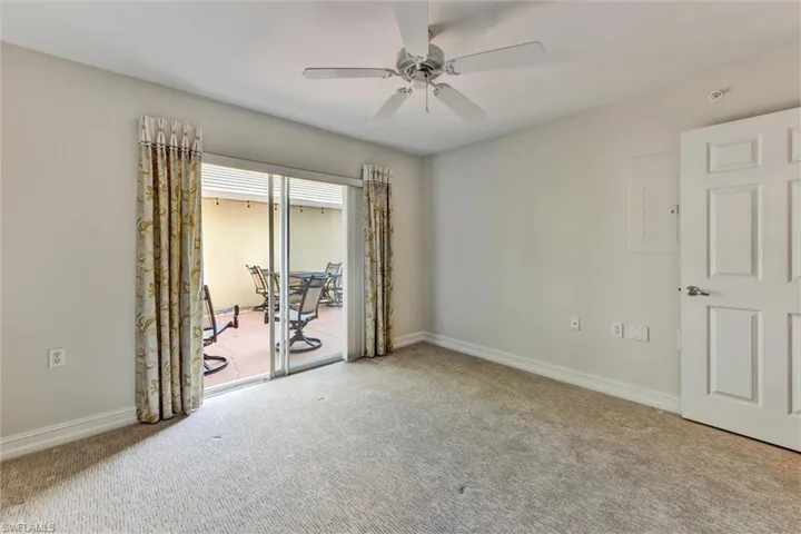 View of Second Bedroom from Closet with Courtyard Access