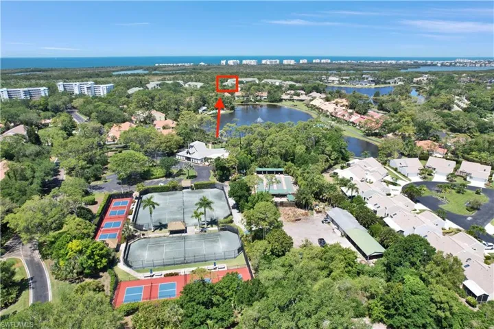 Aerial View of Clubhouse, Tennis, Pickleball & Bocci Courts. Condo location shown with arrow.