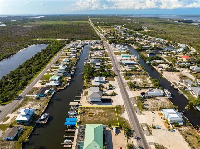 Aerial perspective of suburban area featuring a nearby body of water