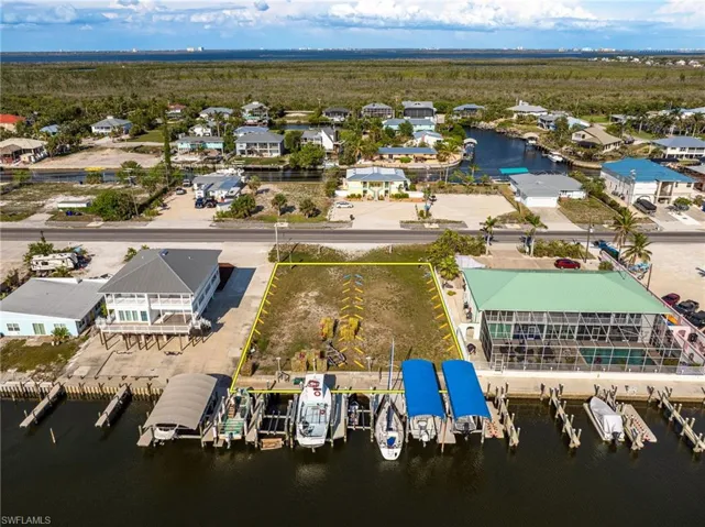 Aerial view of commercial area featuring a nearby body of water