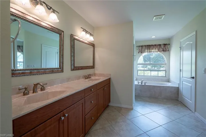 Master bathroom has a linen closet, double vanities, separate tub and shower and water closet.