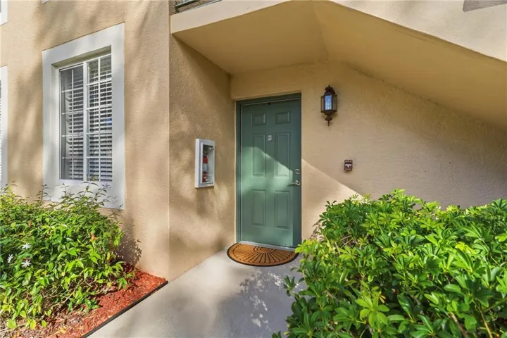 View of exterior entry featuring stucco siding