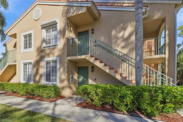View of property with stairs