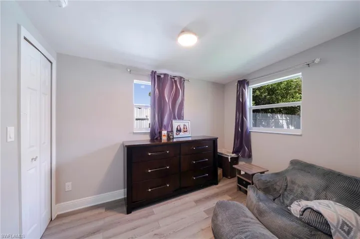 Sitting room with light wood-type flooring and baseboards