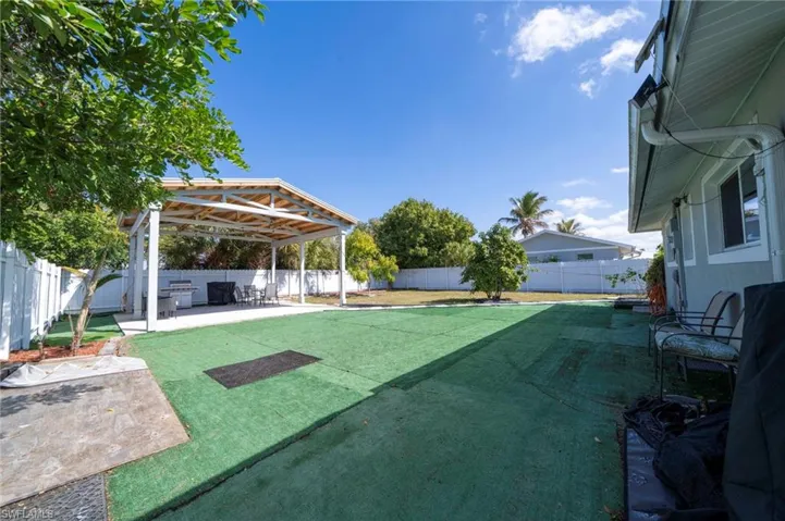 Fenced backyard with a patio area