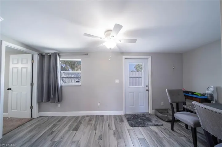 Entrance foyer with a ceiling fan and light wood-style floors