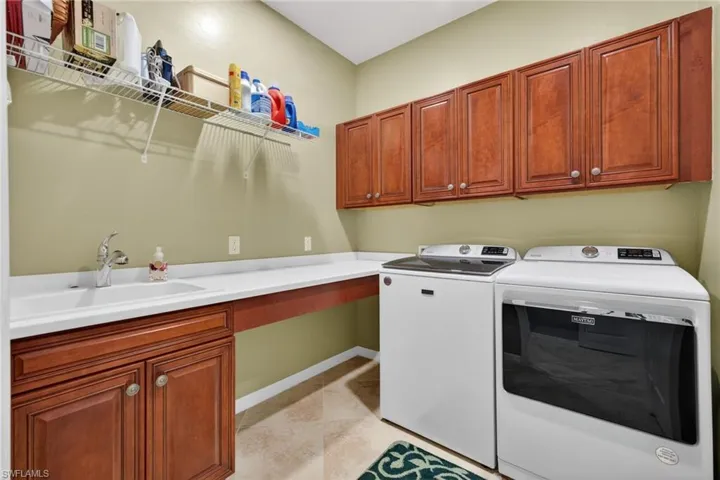 Laundry Room with Utility Sink, Countertop, and Plenty of Cabinets for Storage