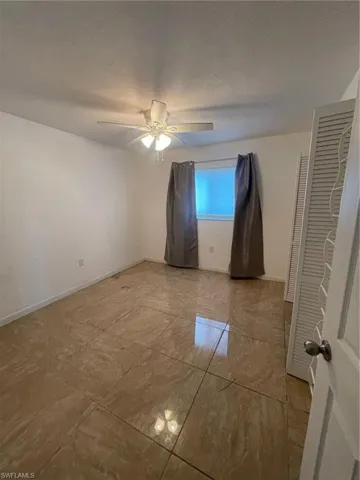 Unfurnished bedroom featuring ceiling fan