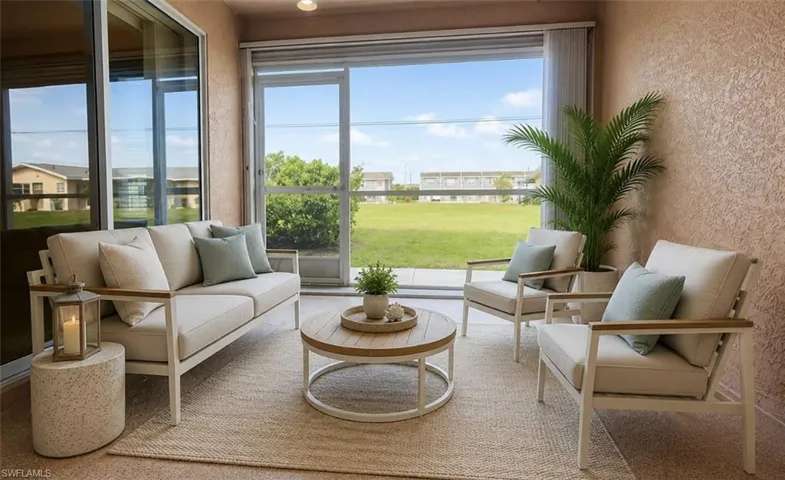 Virtually staged: Screened-in patio featuring textured stucco walls, large sliding glass doors, and a neutral-toned area rug