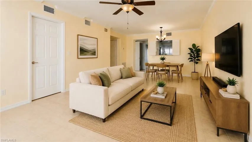 Virtually staged: Open-concept living space featuring tile flooring and a ceiling fan