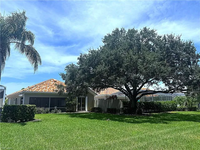 Beautifully landscaped backyard offering a private and serene outdoor setting with lush tropical surroundings and plenty of space to enjoy the Naples lifestyle.