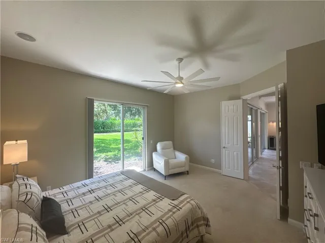 The spacious primary suite features a brand-new king-size bed with a never-used mattress, along with a comfortable power reclining chair—creating the perfect retreat after a day enjoying the Naples lifestyle or Village Walk's resort-style amenities.