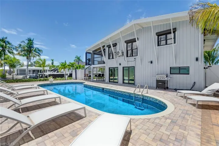 Enjoy sunbathing by the expansive pool and deck area