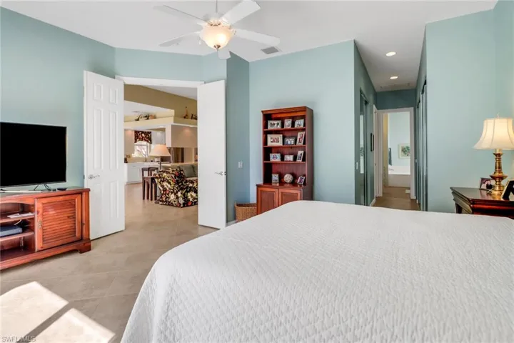 Bedroom featuring light tile patterned floors, recessed lighting, visible vents, a ceiling fan, and connected bathroom