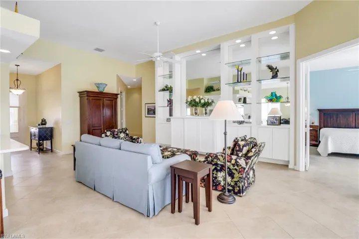 Living area with recessed lighting, visible vents, built in features, a ceiling fan, and light tile patterned flooring