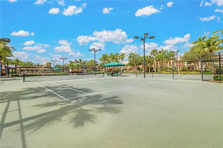 View of tennis court featuring fence