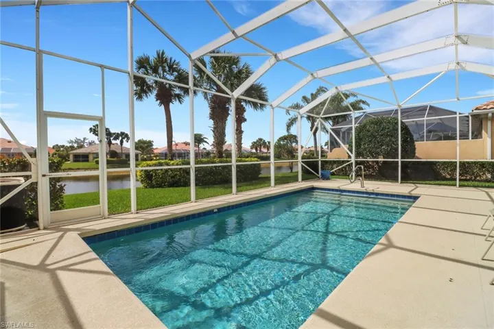 Pool with a patio, a water view, and glass enclosure