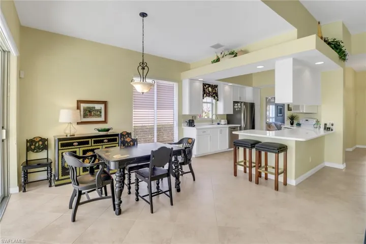 Dining room with light tile patterned flooring, visible vents, and baseboards