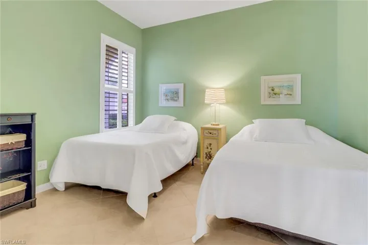 Bedroom featuring baseboards and light tile patterned flooring