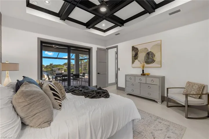 Bedroom featuring access to exterior, coffered ceiling, beamed ceiling, and ceiling fan