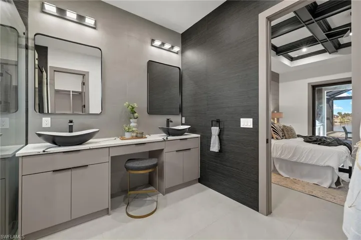 Bathroom with vanity, tile walls, coffered ceiling, and tile patterned floors