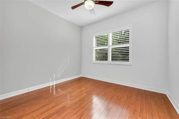 Guest bedroom 4 with ceiling fan and hardwood floors