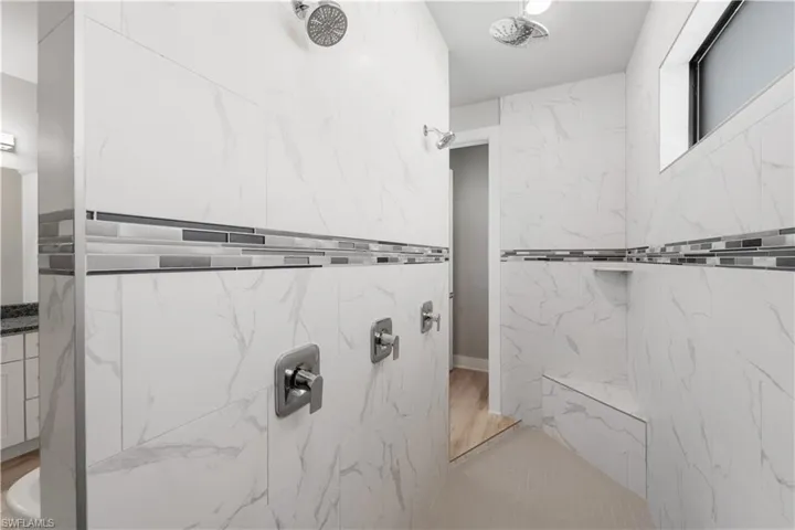 Bathroom featuring a marble finish shower