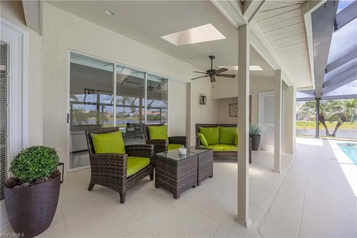 Lanai featuring a ceiling fan, an outdoor living space, a lanai, and a sunroom