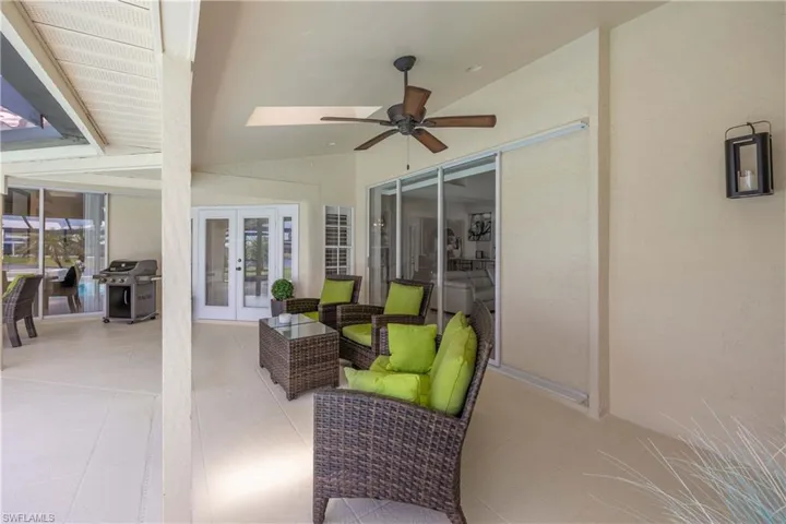 View of patio with grilling area, a ceiling fan, french doors, and an outdoor living space