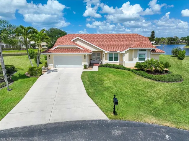 Beautiful home featuring a tile roof, concrete driveway, an attached garage, and a front yard
