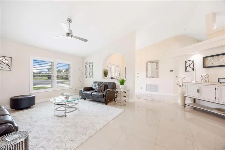 Living area featuring lofted ceiling and a ceiling fan