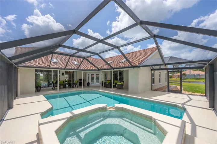 View of swimming pool with a sunroom, a patio area, a pool with connected hot tub, and a lanai