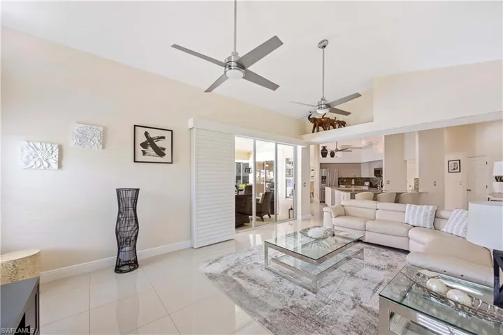 Living room featuring light tile patterned flooring and a ceiling fan